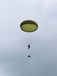 Low angle view of paragliding against sky