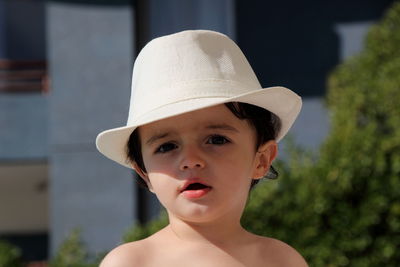 Close-up portrait of boy wearing hat