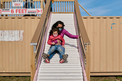 Mom and daughter going down the sllide at the county fair