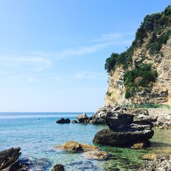 Scenic view of rocks in sea against sky