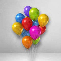 Close-up of multi colored balloons against white background