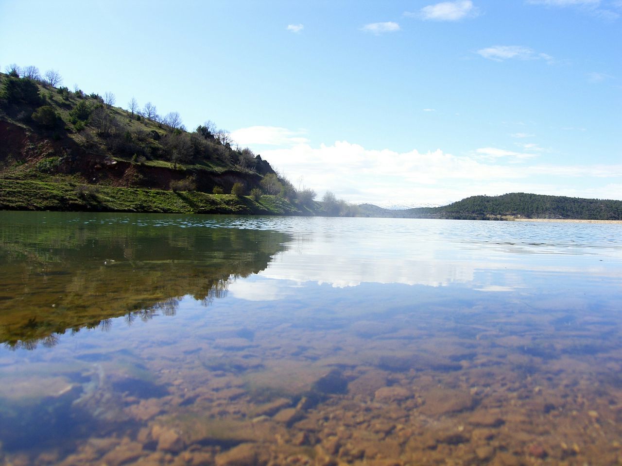 water, reflection, tranquil scene, tranquility, lake, scenics, sky, beauty in nature, waterfront, nature, idyllic, blue, tree, calm, cloud, standing water, non-urban scene, cloud - sky, mountain, day