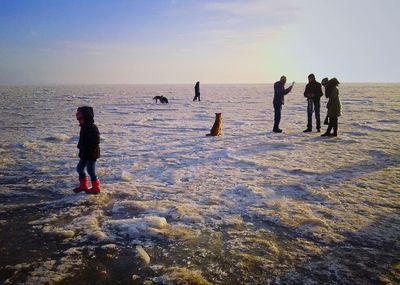 People on beach against sky