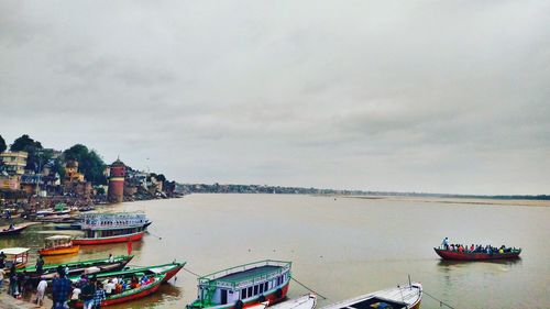 Boats moored on sea against sky