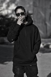 Young man wearing sunglasses standing outdoors