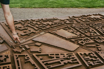 Cropped image of man pointing at city model