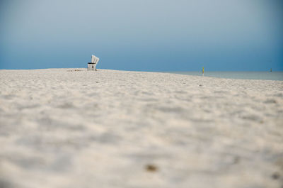 Surface level of beach against clear sky