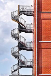 Low angle view of spiral staircase on building against sky
