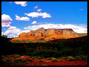 View of rock formations against cloudy sky