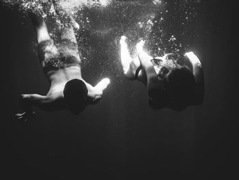 Couple swimming underwater