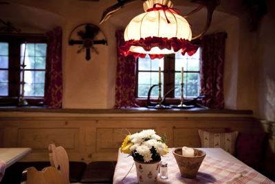 Illuminated lantern over table at restaurant