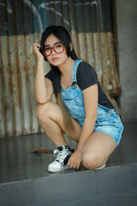 Portrait of young woman sitting on table