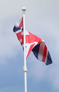 Low angle view of flags flag against sky