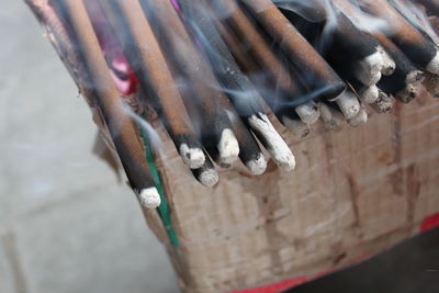 Close-up of lit incense sticks at temple