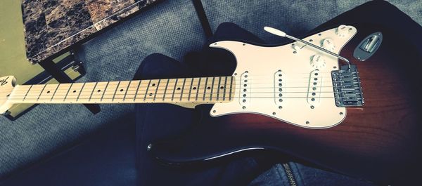 High angle view of guitar on table