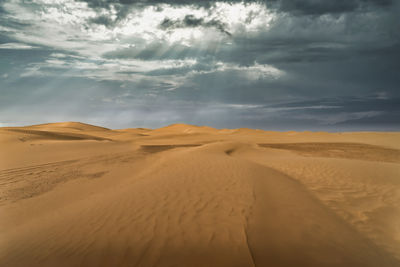 Scenic view of desert against sky during sunset