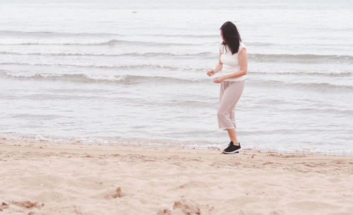 Woman standing on beach