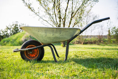 Close-up of wheelbarrow on field