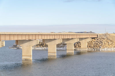 Bridge over sea against clear sky