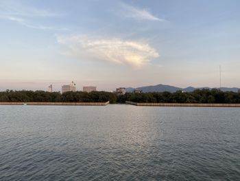 Scenic view of lake by building against sky