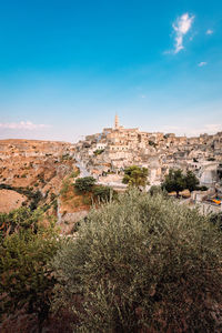 Wide view of the sassi di matera from the belvedere colombo blue sky with clouds, vertical