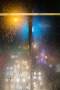 Abstract image of glass window against sky at night