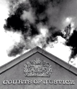 Low angle view of building against cloudy sky