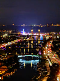 High angle view of illuminated buildings in city at night