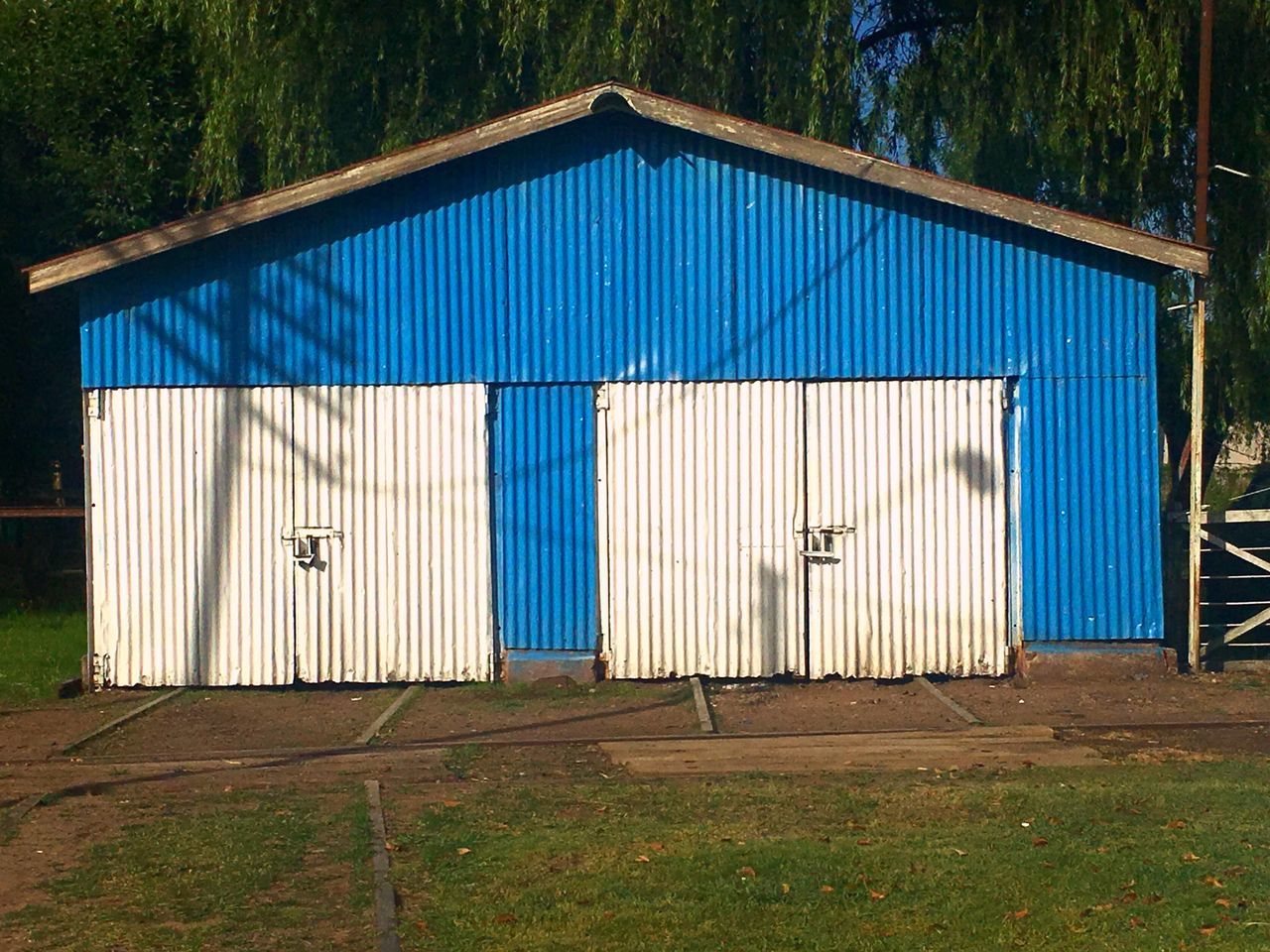 no people, sunlight, outdoors, built structure, tree, architecture, day, nature, sky, sliding door