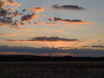 Scenic view of field against sky during sunset