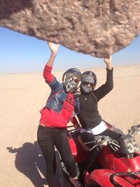 Portrait of women with quadbike in desert