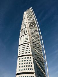 Low angle view of modern building against blue sky