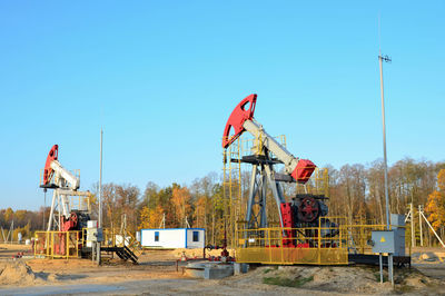 Traditional windmill on field against clear blue sky