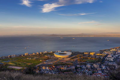 High angle view of buildings by sea against sky