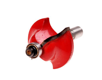 Close-up of red bottle against white background