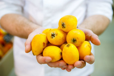 Close-up of hand holding fruits