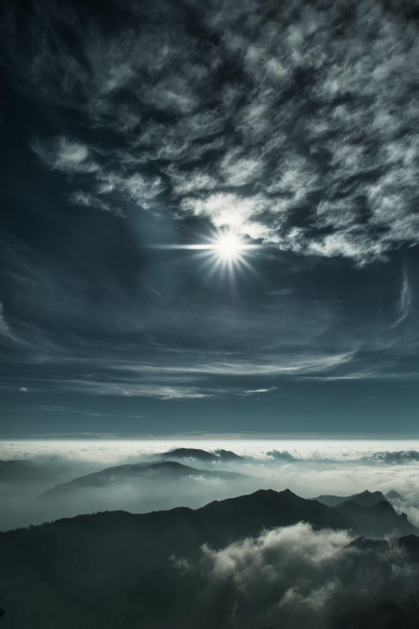 sky, cloud, darkness, beauty in nature, scenics - nature, environment, horizon, nature, dramatic sky, cloudscape, mountain, tranquility, sunbeam, light, sunlight, tranquil scene, landscape, no people, mountain range, outdoors, black and white, idyllic, monochrome, fog, atmospheric mood, sun, overcast, awe, storm, dark, moody sky, moonlight, dawn