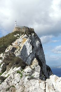 Low angle view of rock formation against sky