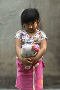 Portrait of girl holding toy