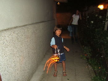 Full length of boy holding jack o lantern