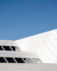 Low angle view of building against clear blue sky