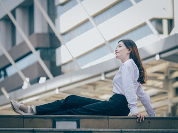 Young woman sitting on floor