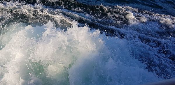 High angle view of waves splashing on sea