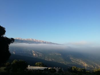 Scenic view of mountains against clear blue sky