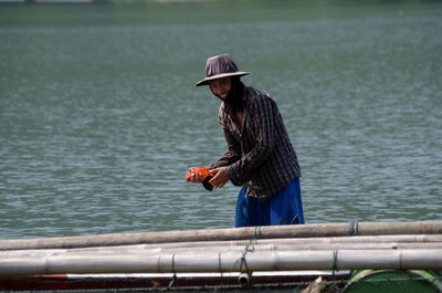 Portrait of smiling man fishing in lake