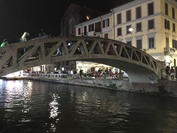 Bridge over river in city at night