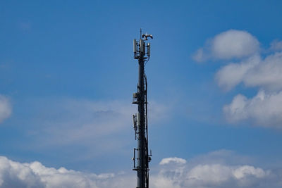 Low angle view of communications tower against sky. false stork