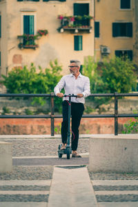 Full length of man standing against wall in city