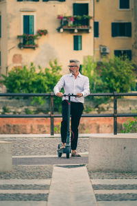 Full length of man standing against wall in city