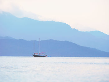 Lonely boat on clam sea background. pastel colors.